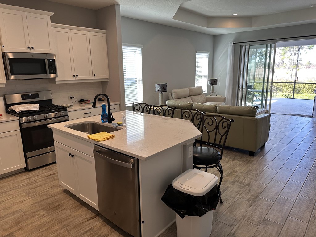 a kitchen with an island and a living room with a couch