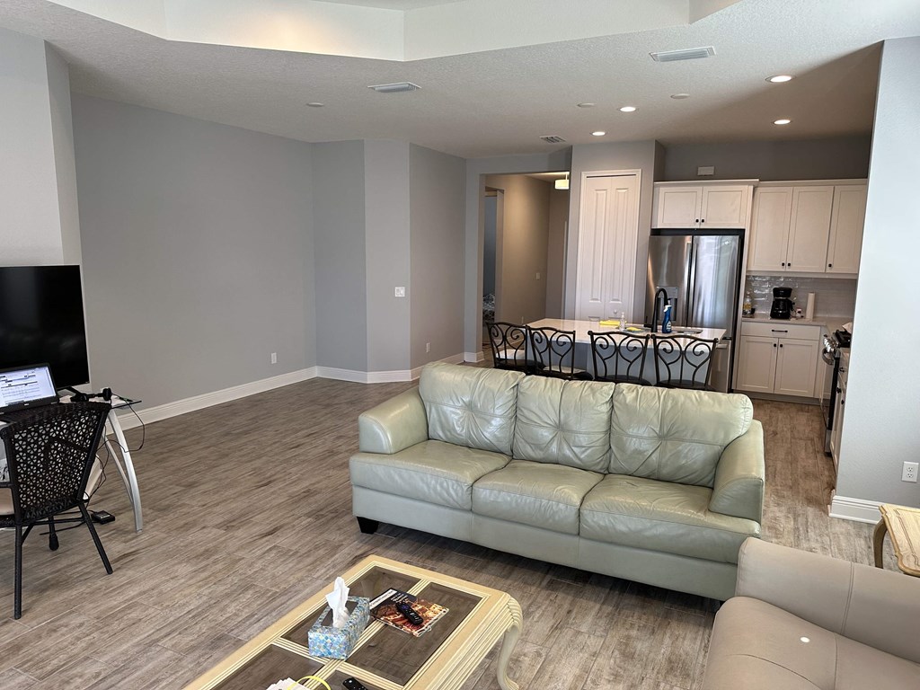 a living room and kitchen with a couch and a table