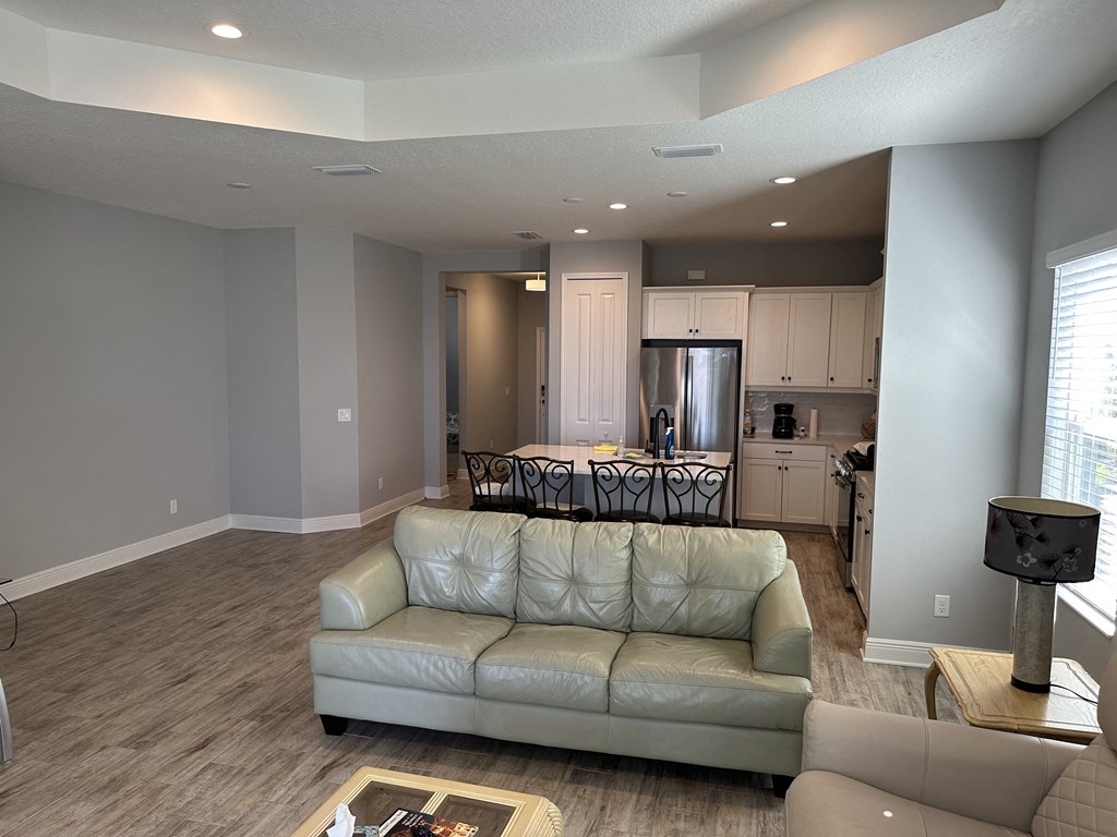 a living room with a couch and a kitchen