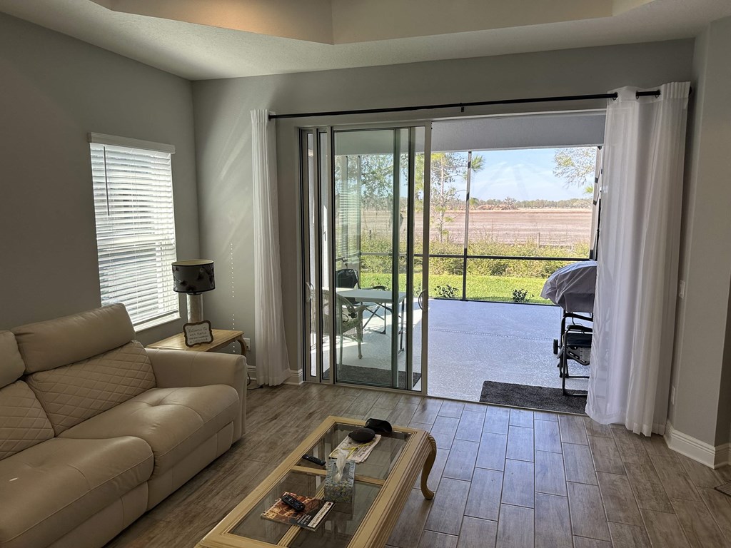 a living room with a couch and a sliding glass door
