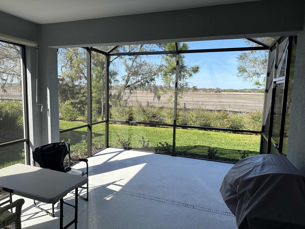 a room with a large window and a view of a field
