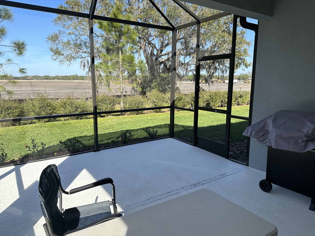 a room with a large glass window and a view of a field