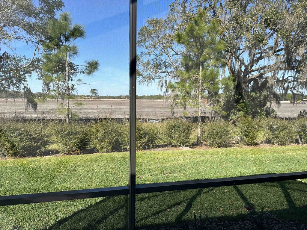 a view of a field from a glass window