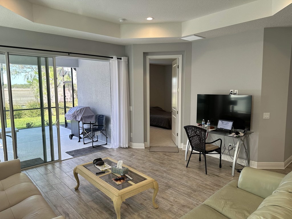 a living room with a couch and a desk and a tv