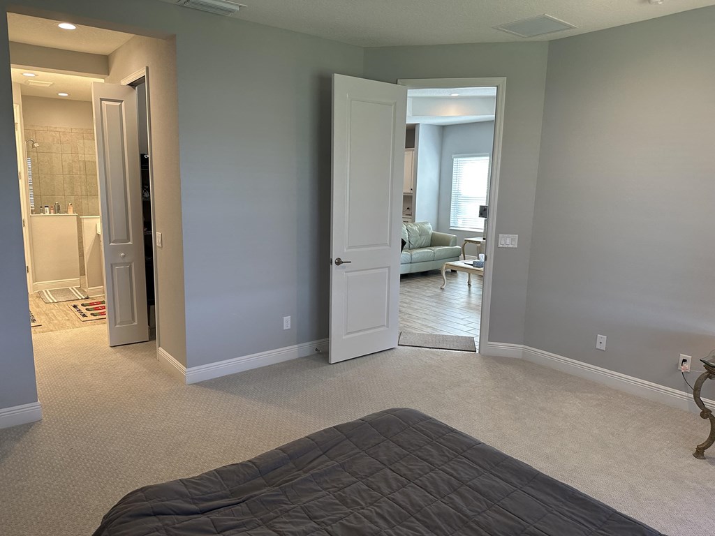 a bedroom with a bed and a closet and a bathroom