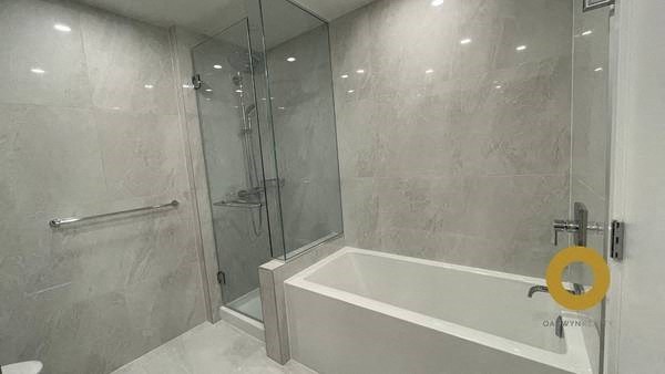 a bathroom with a shower and a bath tub
