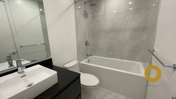 a bathroom with a tub sink and a toilet