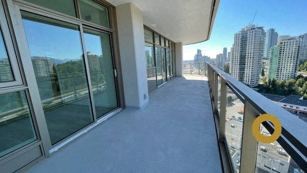 a balcony with a view of a city and a large window