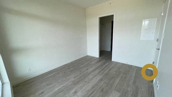 an empty room with white walls and wooden floors