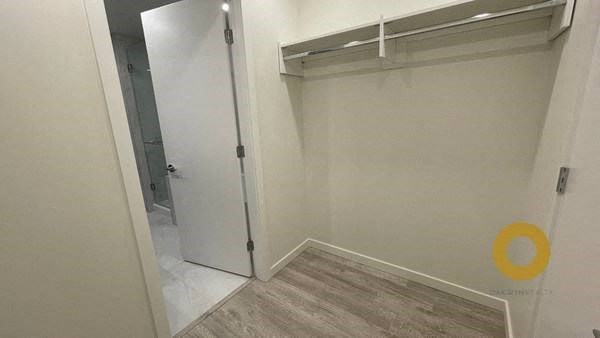 a white closet with a sliding door in a room