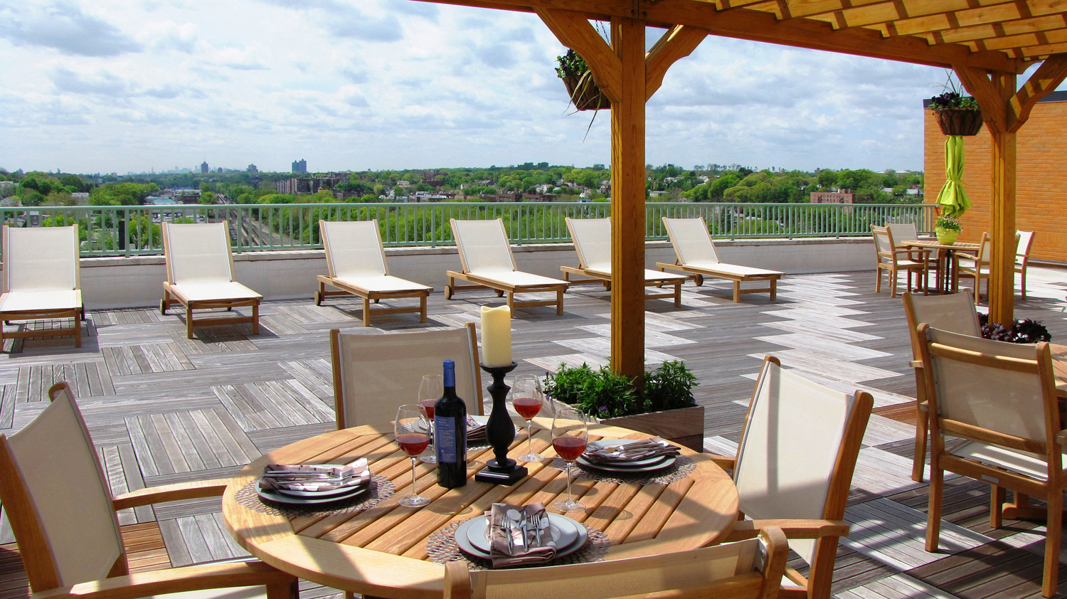 a patio with a table and chairs on a roof