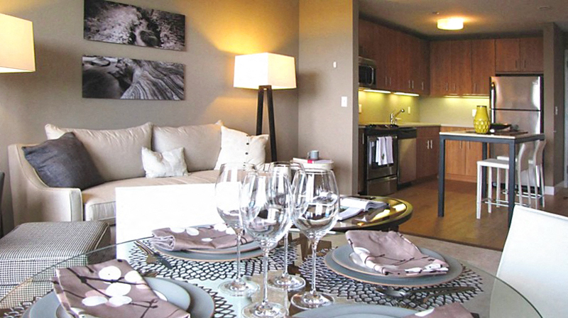 a living room and kitchen with a glass table