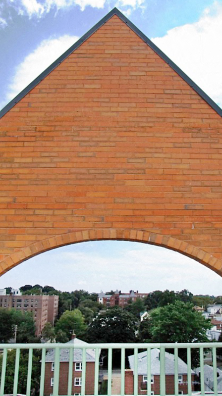 a view of the arch of a brick building from under it