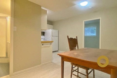 A kitchen with a table and a chair.