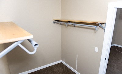 a walk in closet with a bar and a desk