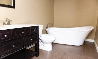 a bathroom with a toilet and a tub and a sink