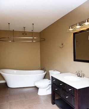 a bathroom with a tub and a sink and a mirror
