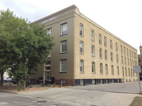 a large brick building on the side of a street