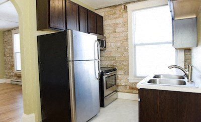 a kitchen with a stainless steel refrigerator and a sink