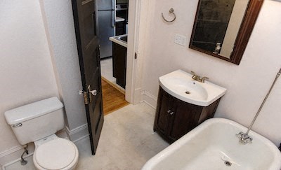a bathroom with a toilet and a sink and a bath tub