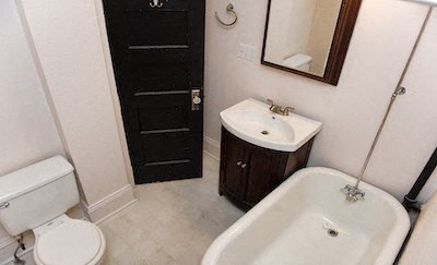 a bathroom with a sink toilet and a mirror