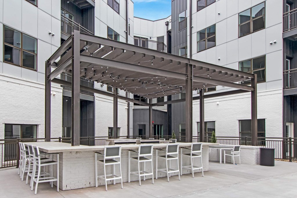 a communal patio with tables and chairs in front of an office building