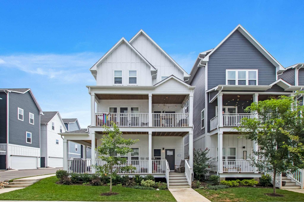 a row of houses with stairs and balconies