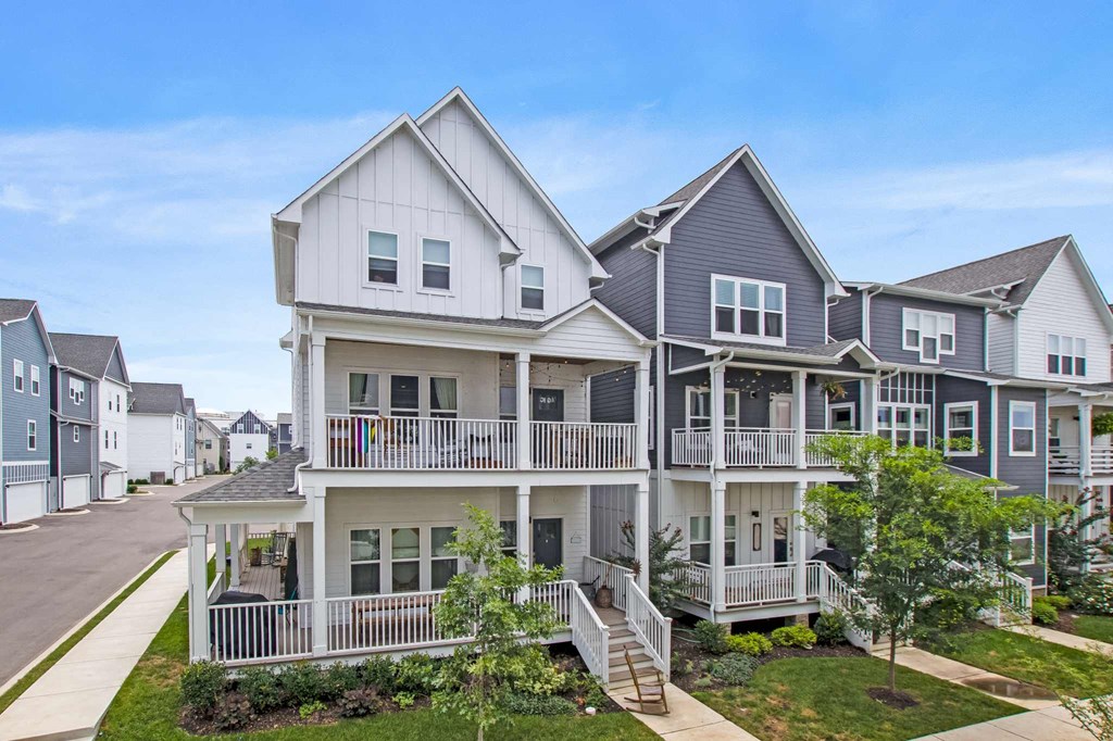 a row of houses with balconies on the side of a street