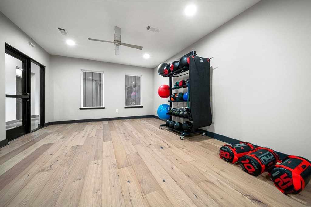the exercise room is equipped with a home gym and weights