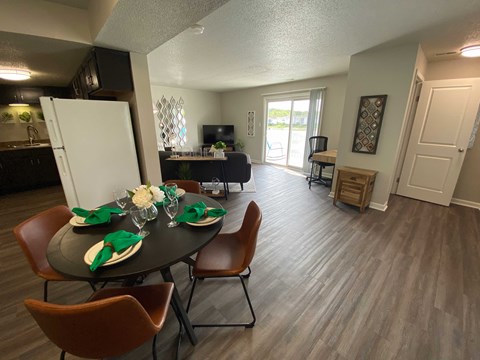 A dining room with a table set for a meal.