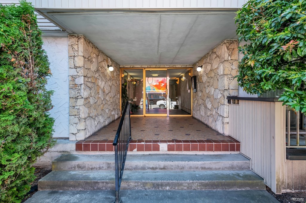 A house entrance with a black metal railing.