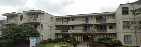 Apartment building with a cloudy sky in the background.