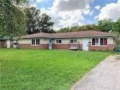 a house with a yard and a road in front of it