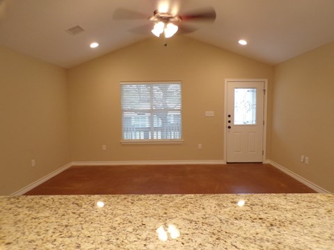 a dining room with a table and a ceiling fan