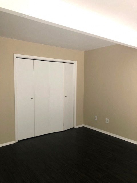 an empty room with a white closet in it