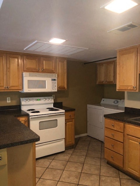 a kitchen with white appliances and wooden cabinets