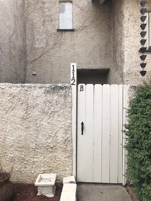 a white gate in front of a white door