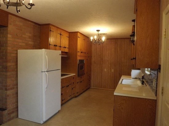 a kitchen with a refrigerator and a sink