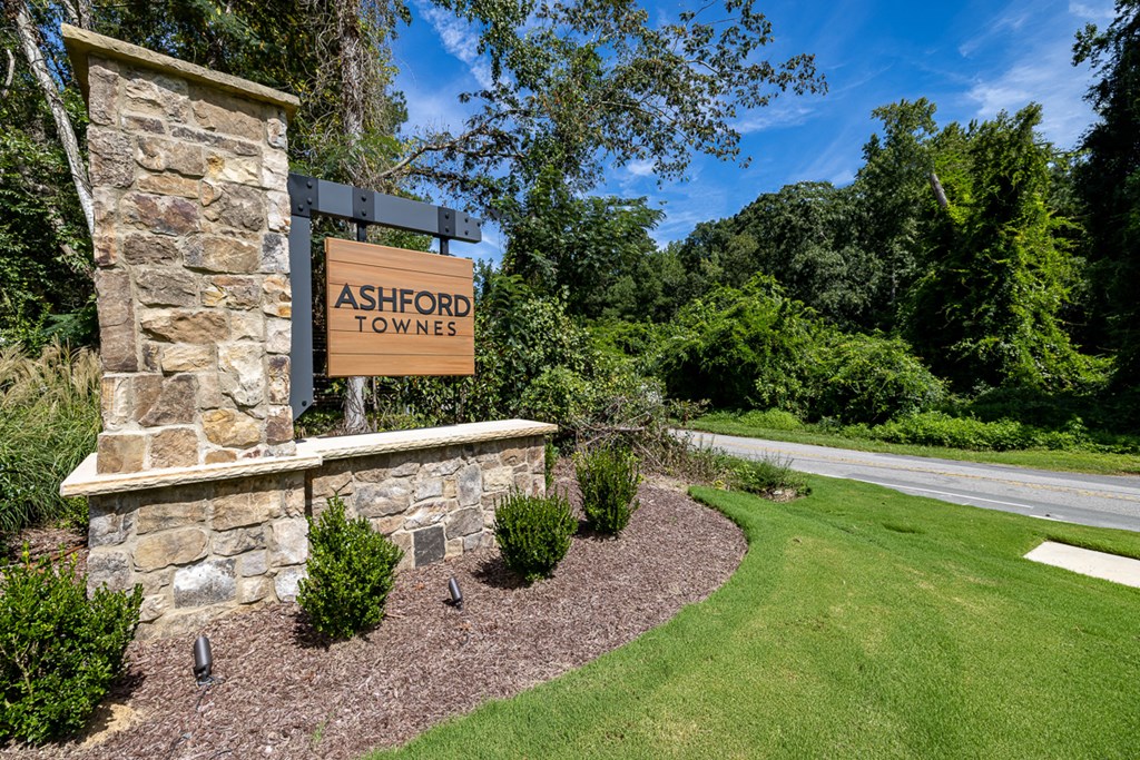a sign for ashcroft towers on the side of a stone building