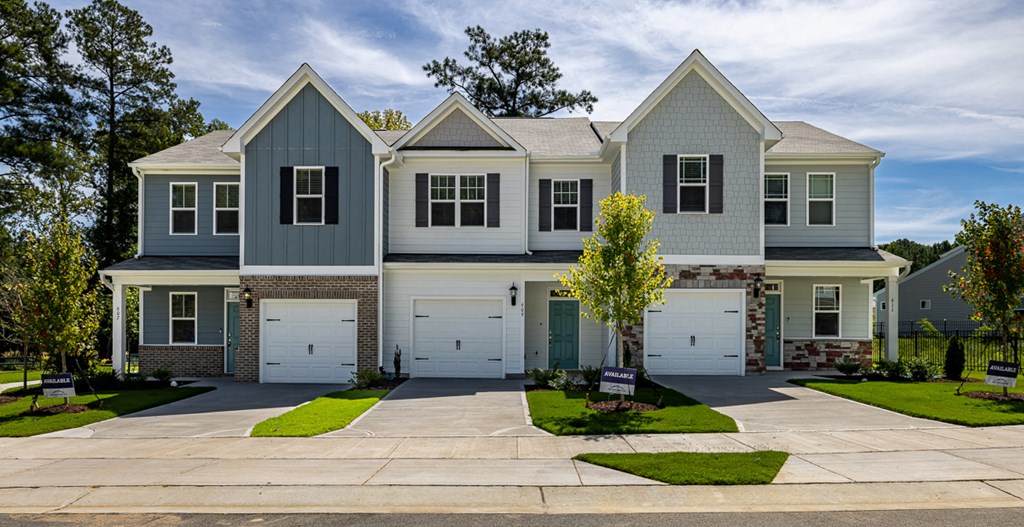 a large house with white doors and a driveway
