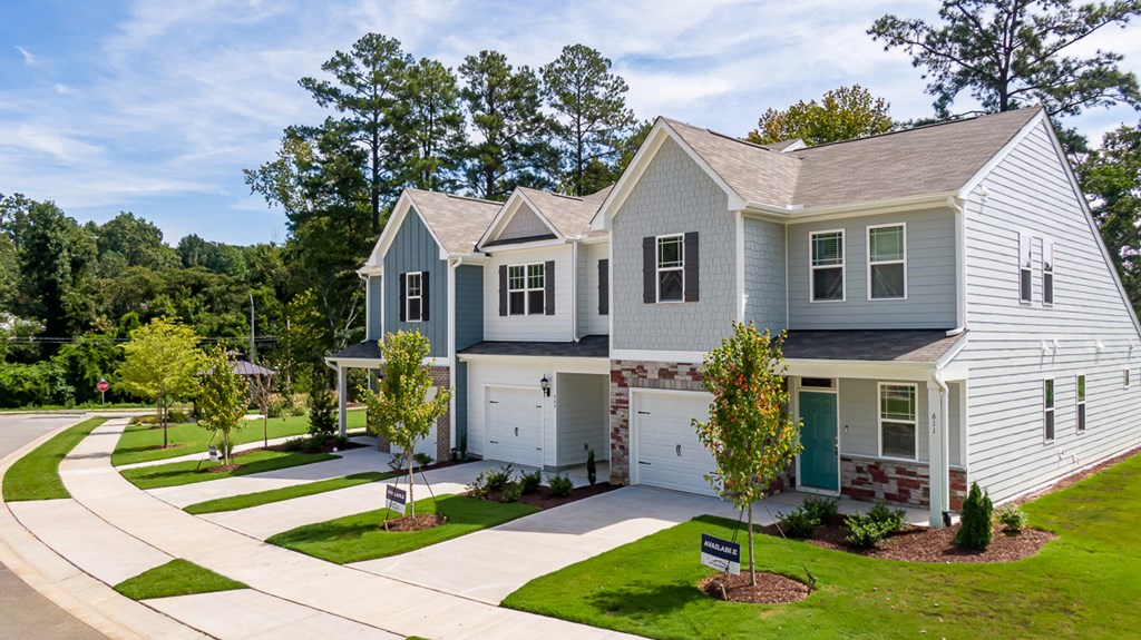 a blue and white house on the side of a street