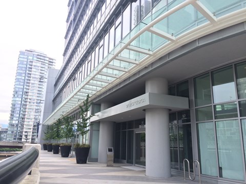 The entrance to a building with a glass facade and a sign that reads "West Technical".