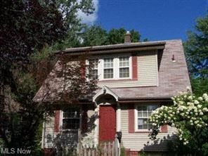 A house with a red door and a window with white trim.