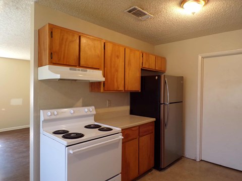 a kitchen with a stove and a refrigerator