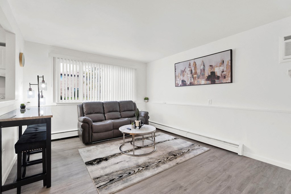 A living room with a brown sofa and a coffee table.