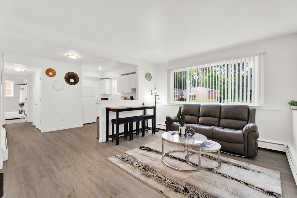 A living room with a grey couch and a coffee table.