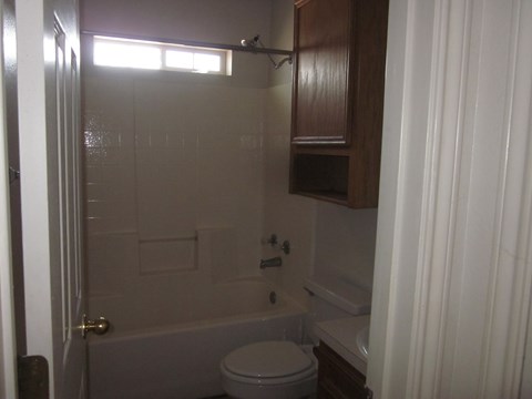 a bathroom with a tub and a toilet and a sink