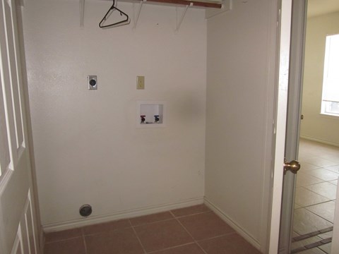 an empty room with a white wall and a door