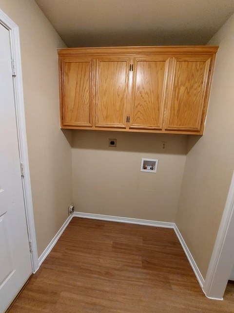 A room with wooden floors and a white door.