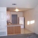 an empty living room and kitchen in a house